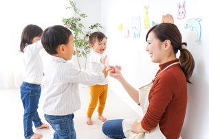 nursery-school-teacher-playing-kids